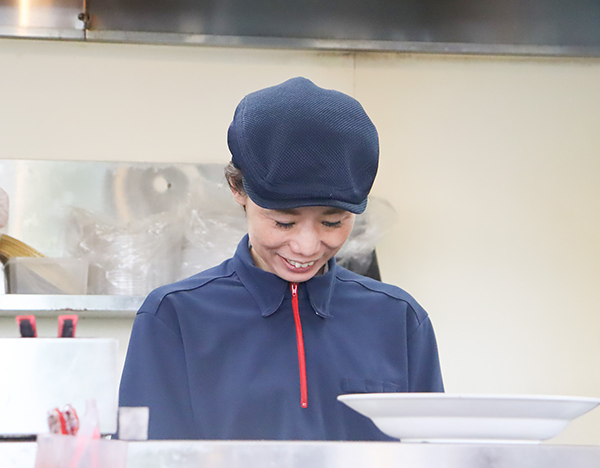 キッチンで作業をしている主婦Oさん