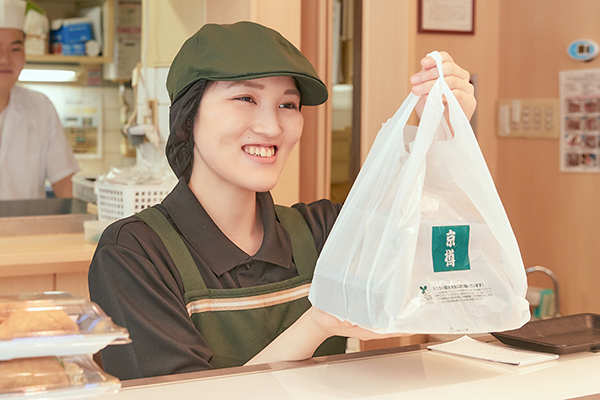 店頭で笑顔で接客しているスタッフ